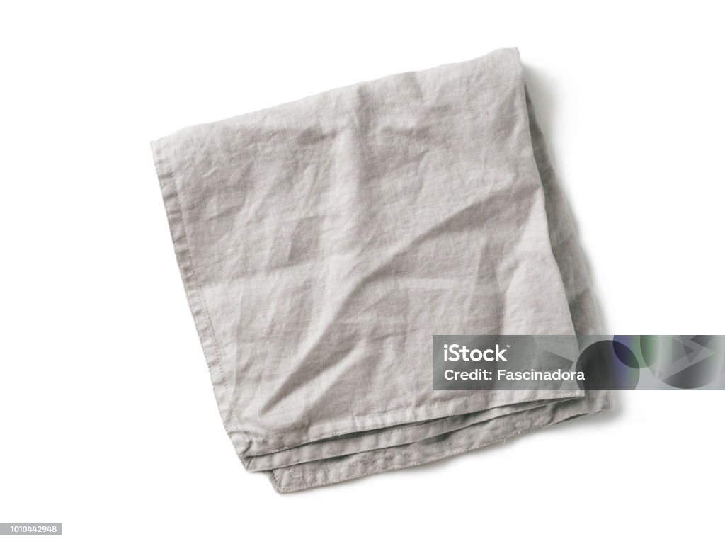 Gray linen napkin isolated on white Folded gray linen napkin isolated on white background. Natural light gray linen napkin. Isolated on white with clipping path. Top view or flat lay. Napkin Stock Photo