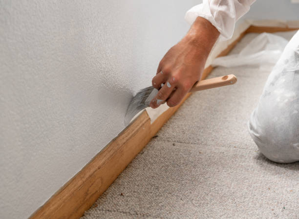 istock Man painting interior of home by window 1010443622