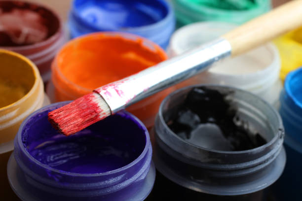 Bright colorful paints for drawing and a brush