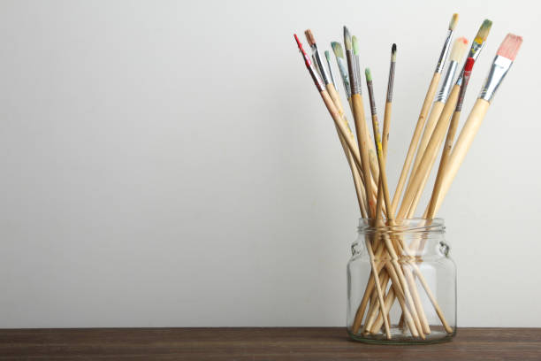 istock Paint brushes stand in a glass jar 1010443786