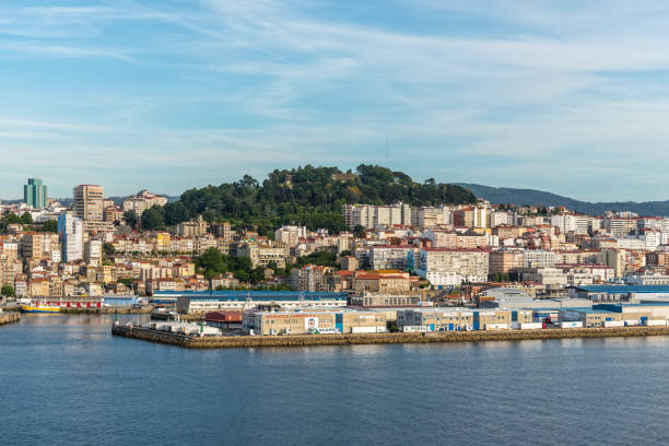 Vigo, Spain - May 20, 2017: Cityscape of the Vigo in Galicia, Spain. Company of seafood and sea delicacies in the foreground.