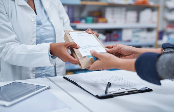 Your prescription is ready for collection Closeup shot of an unrecognizable pharmacist assisting a customer in a chemist pharmacy photos stock pictures, royalty-free photos & images