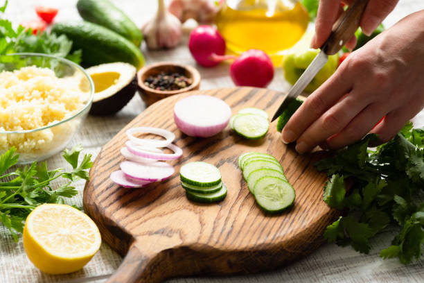 istock Female cutting fresh vegetables for salad 1010456244