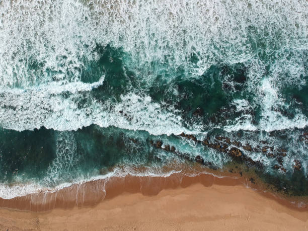 istock Aerial photo of waves on beach 1010456476