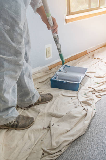 istock Man painting with paint roller 1010466994