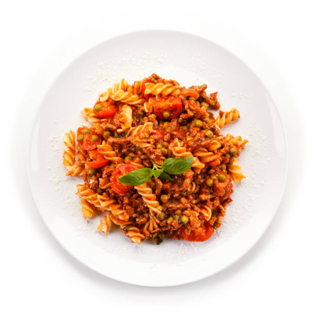 istock Pasta with meat and vegetables on white background 1010467634