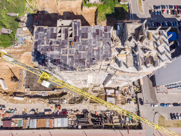 istock drone photo of new building under construction with tower cranes 1010469796