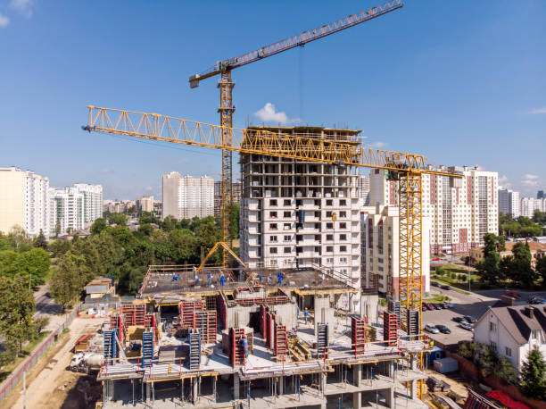 istock tower cranes working at construction site against blue sky background 1010474224