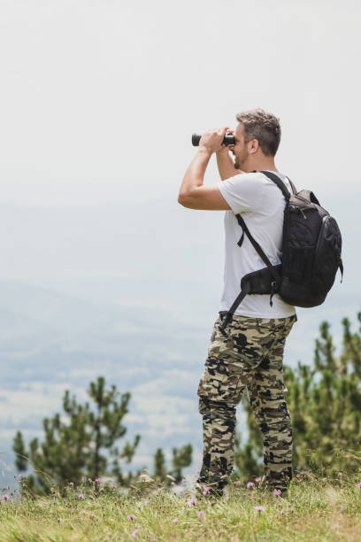 istock Man enjoying the nature and looking through binoculars 1010481886