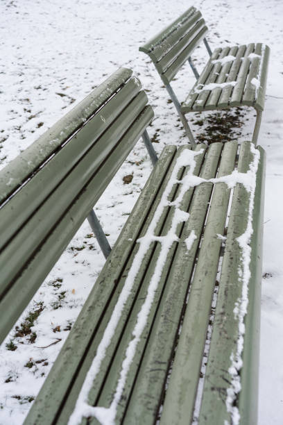 istock green bench covered in snow in winter 1010482182