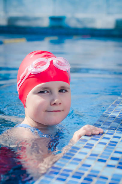 istock Young girl learning to swim in the pool 1010482308