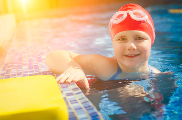istock Young girl learning to swim in the pool 1010482380