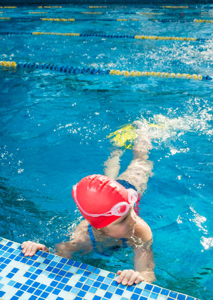 istock Young girl learning to swim in the pool 1010482546