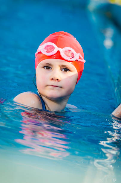 istock Young girl learning to swim in the pool 1010482678