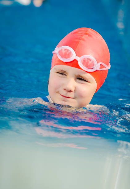 istock Young girl learning to swim in the pool 1010482716