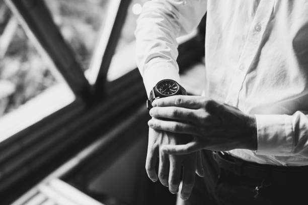 Man in white shirt wearing black watches. Black and white style photo stock photo