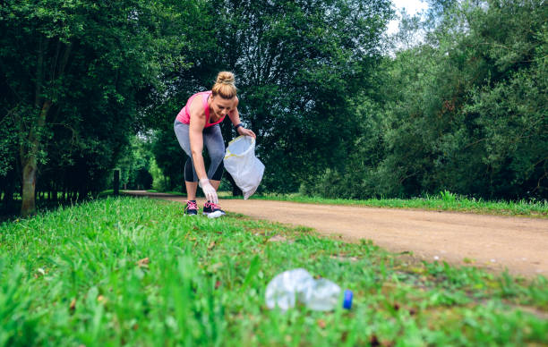 istock Girl picking up trash doing plogging 1010488998