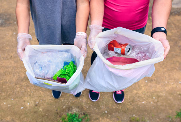istock Plogging. Girls showing garbage 1010491074