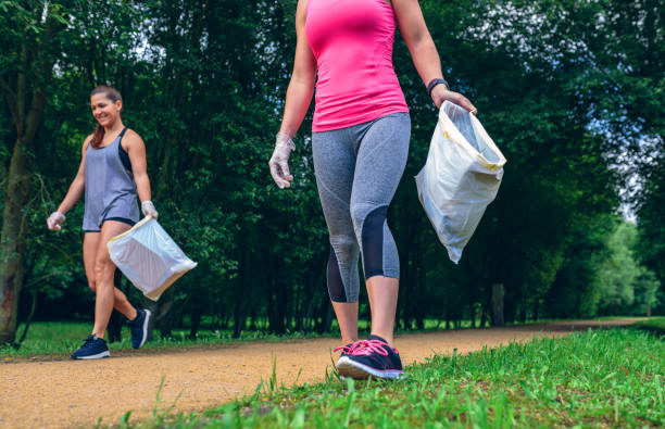 istock Girls with garbage bag doing plogging 1010491138
