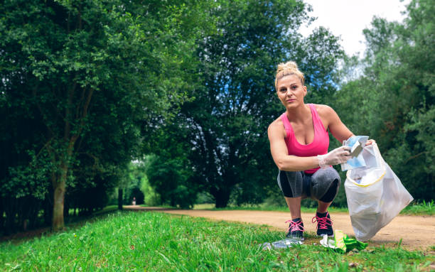 istock Girl picking up trash doing plogging 1010491226
