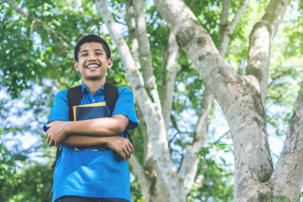 istock happy Asian boy student holding book walking to school 1010491810