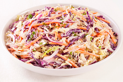 Coleslaw - a family size bowl of healthy coleslaw, made with green and red cabbage, carrot, red onion and a dressing with mayonnaise and low fat yoghurt.