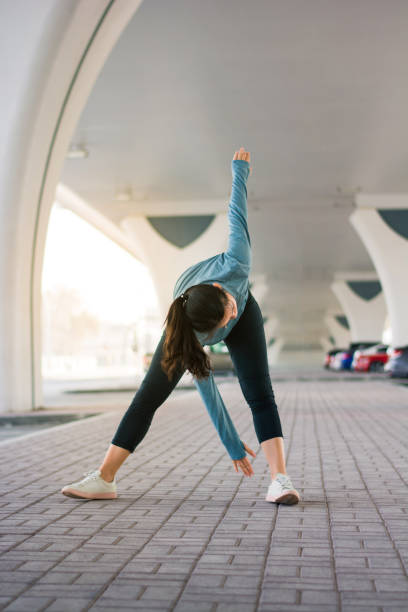 istock Girl stretching before workout on the parking lot 1010503972