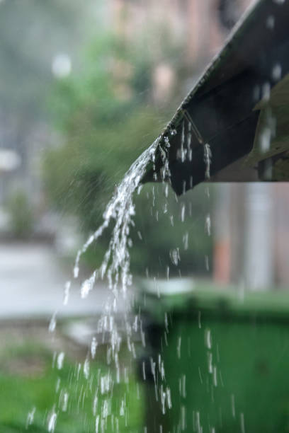 istock Storm rain drips down from the roof with a powerful stream 1010507206