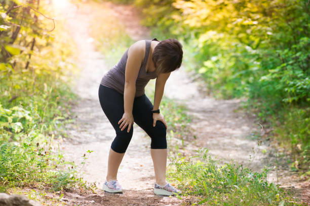 istock Woman tired while jogging, outdoor exercise 1010507300