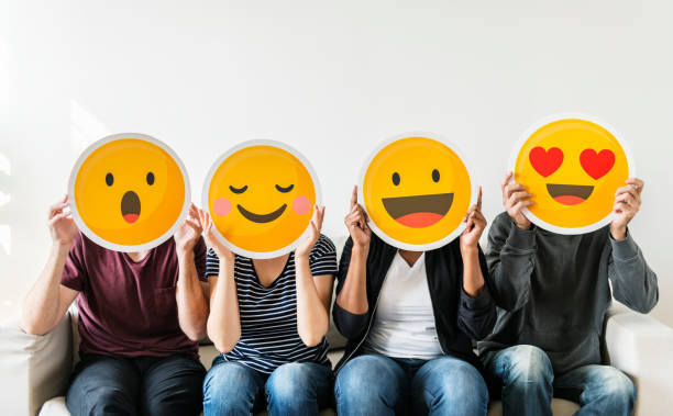 Diverse people holding emoticon