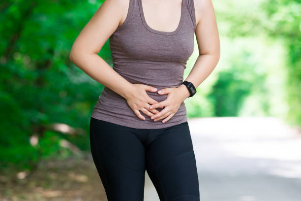 Woman with abdominal pain, injury while running, trauma during workout Woman with abdominal pain, injury while running, trauma during workout, outdoors concept incontinence stock pictures, royalty-free photos & images