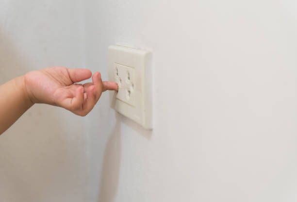 istock Soft focus of baby hand playing with electrical power socket, Dangerous situation at home. 1010510610