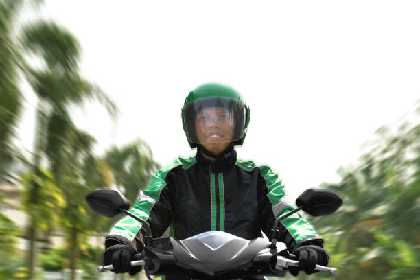 istock Asian motorcycle taxi rider rushing 1010511254