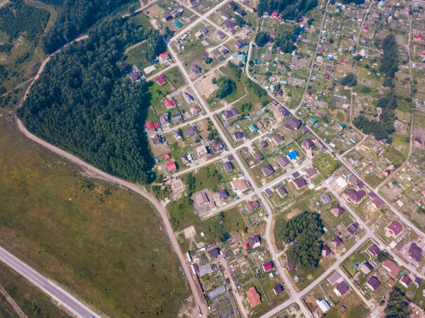 istock Helicopter drone shot forest, city and road 1010511304