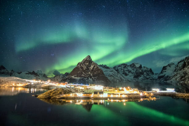 istock Aurora borealis over mountains in scandinavian village glowing 1010514554