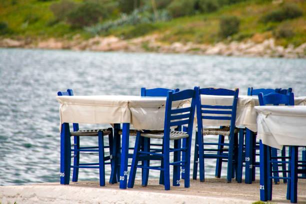 istock Tables and blue chairs by the seaside. Greece 1010514972
