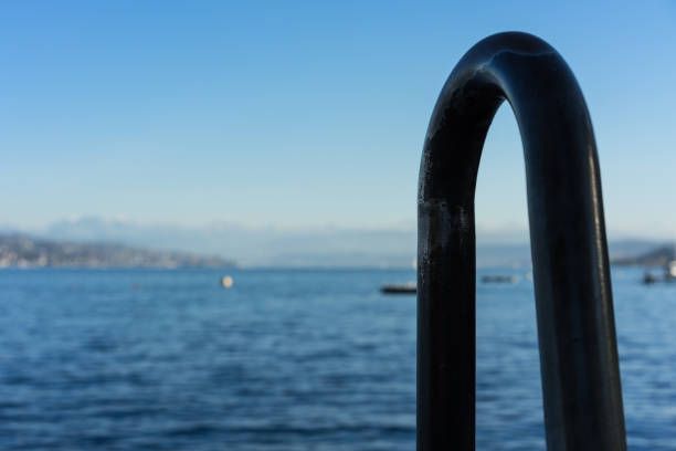 metal handle at swimming entrance with blue water lake view