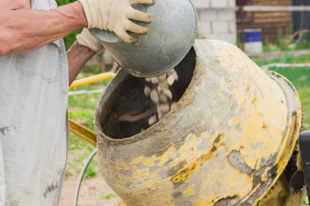 istock construction worker makes concrete in rotating concrete mixer. process of creating cement on the construction site 1010517526