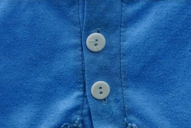 istock two white buttons on a piece of blue cloth clothes 1010526552
