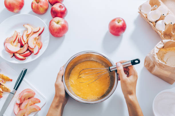 istock Top view female hands whisk eggs for apple pie 1010526672