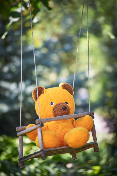 istock Close-Up Of Teddy Bear On Swing 1010531256