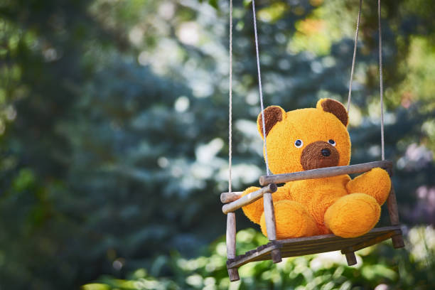 istock Close-Up Of Teddy Bear On Swing 1010533652