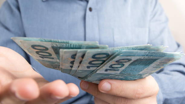 istock Midsection Of Man Holding Paper Currency 1010538174