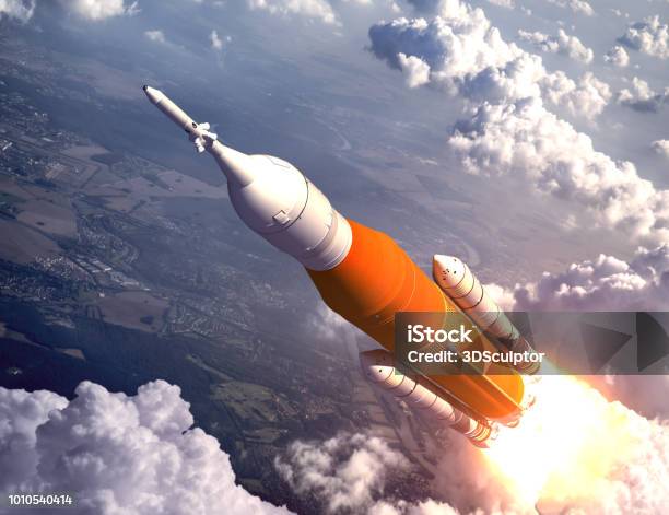 American Space Launch System Flying Over The Clouds Stock Photo - Download Image Now