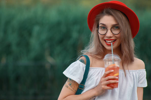istock A Young stylish woman having a refreshing drink while walking 1010540422