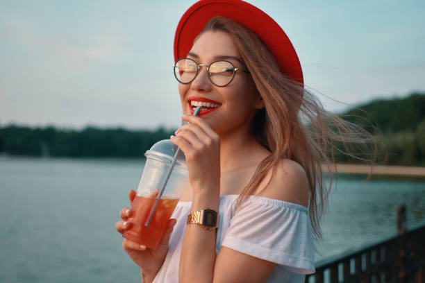 istock A Young stylish woman having a refreshing drink while smiling 1010540458
