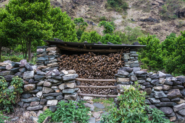 stock of firewood under the roof of a stone barn, nepal. - 15851 imagens e fotografias de stock