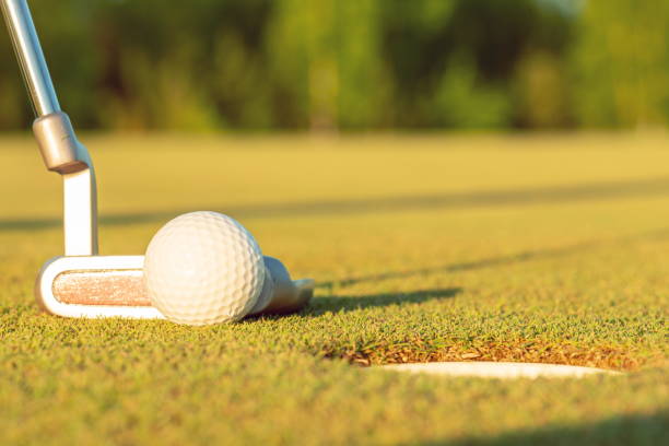 istock golf ball on lip of cup 1010550030