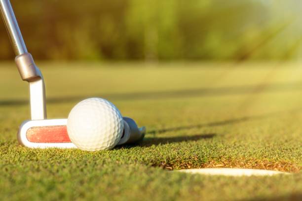 istock golf ball on lip of cup 1010550508