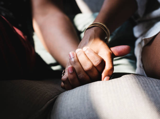 Closeup of couple holding hands